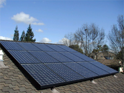 A solar panel on the roof of a house.